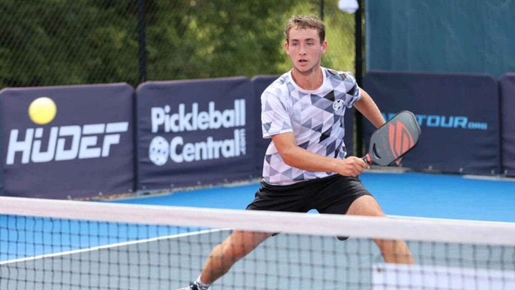 A pickleball player in action on the court, using pickleball paddles with the largest sweet spot for precise shots.