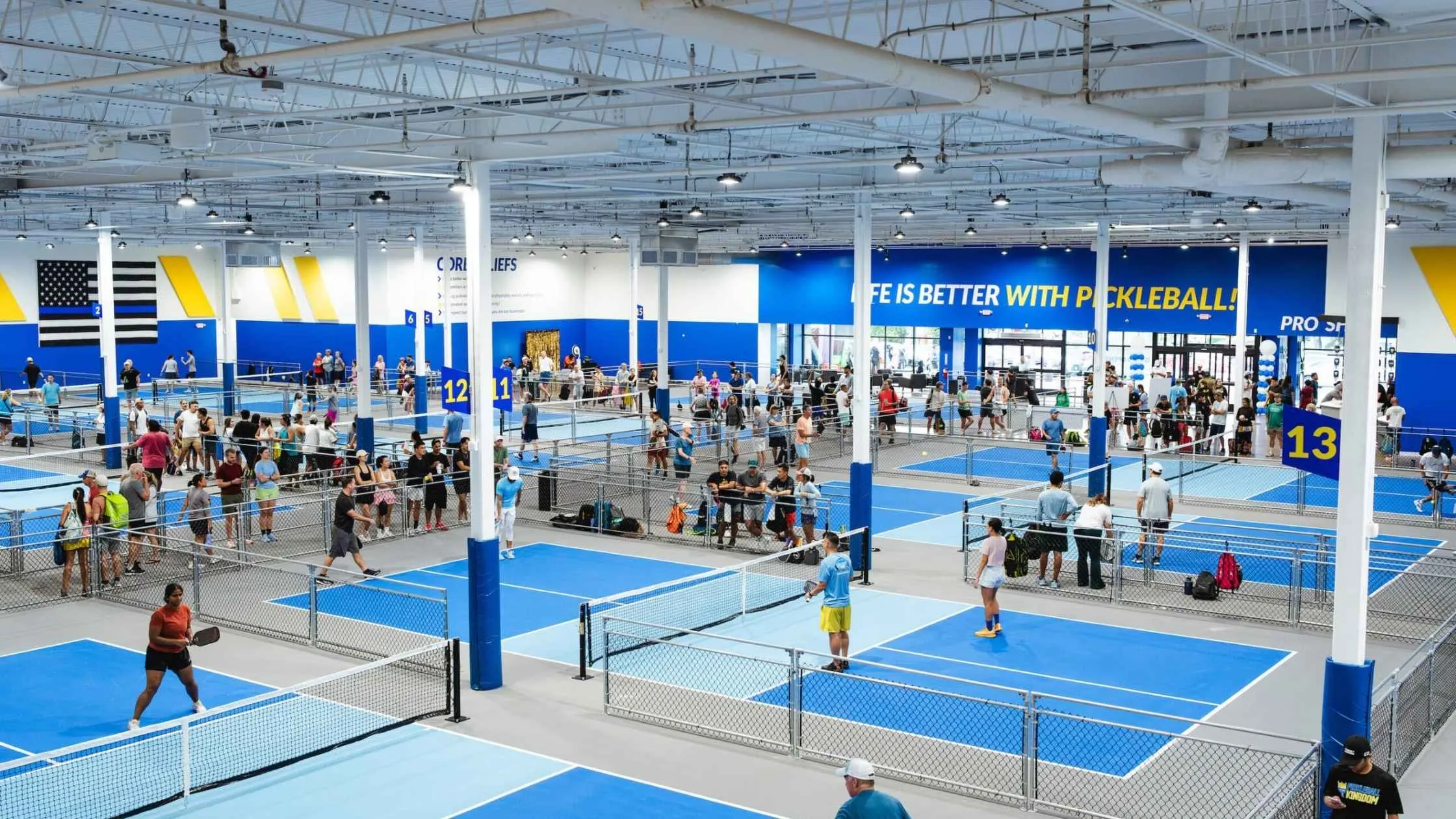 Indoor pickleball courts filled with players enjoying the fastest growing sport in a vibrant, modern facility.