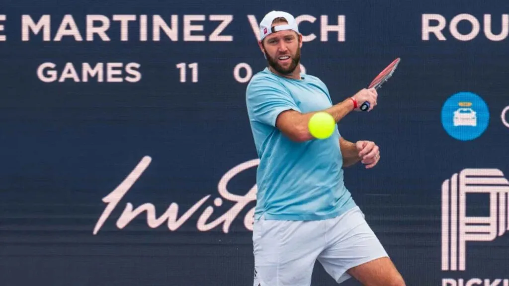 Professional athlete executing a powerful forehand shot during a competitive match, demonstrating pickleball singles strategy for advanced players.
