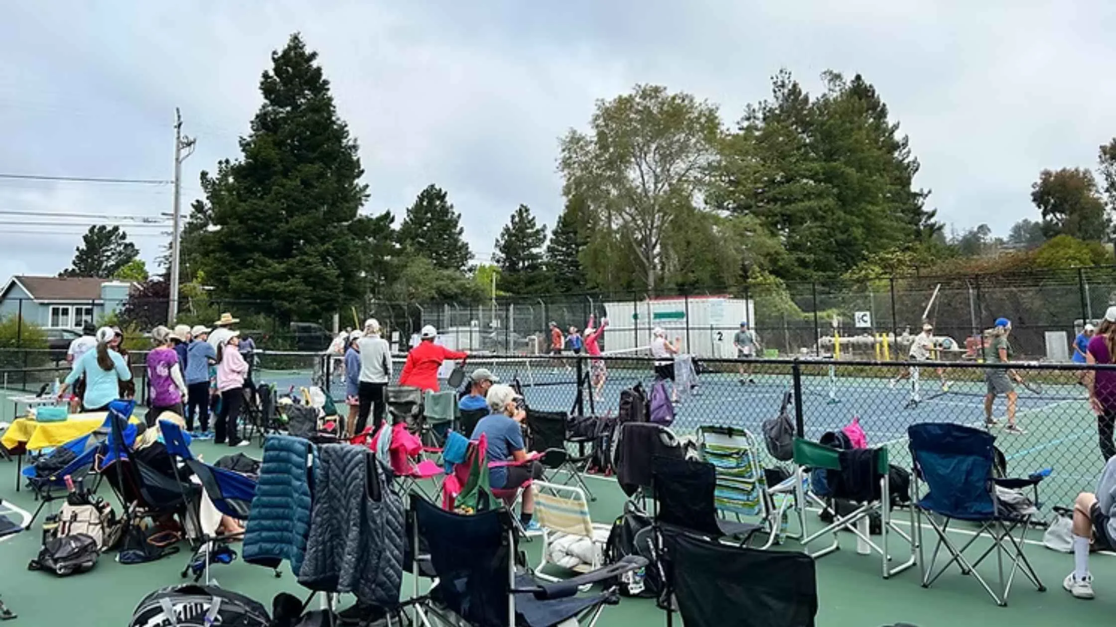 Players and spectators enjoying outdoor pickleball tournaments near Santa Cruz, CA, with courts full of exciting matches.