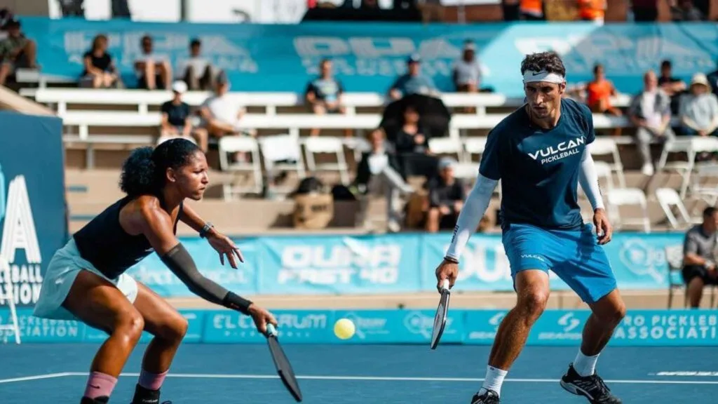 Mixed doubles pickleball strategy in action with two focused players at the net.